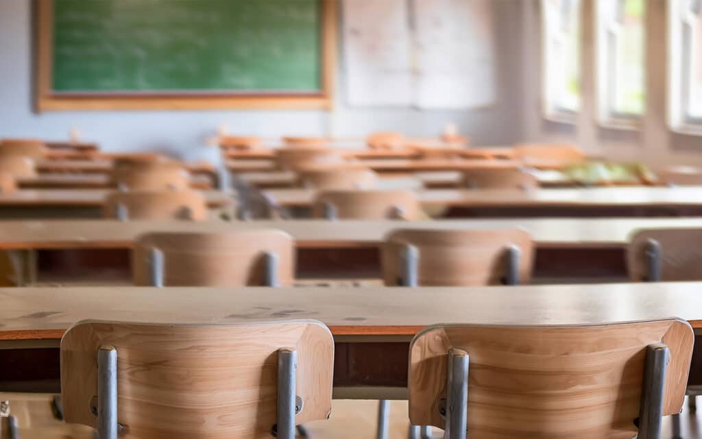 Photo of a classroom with a blackboard in the background.