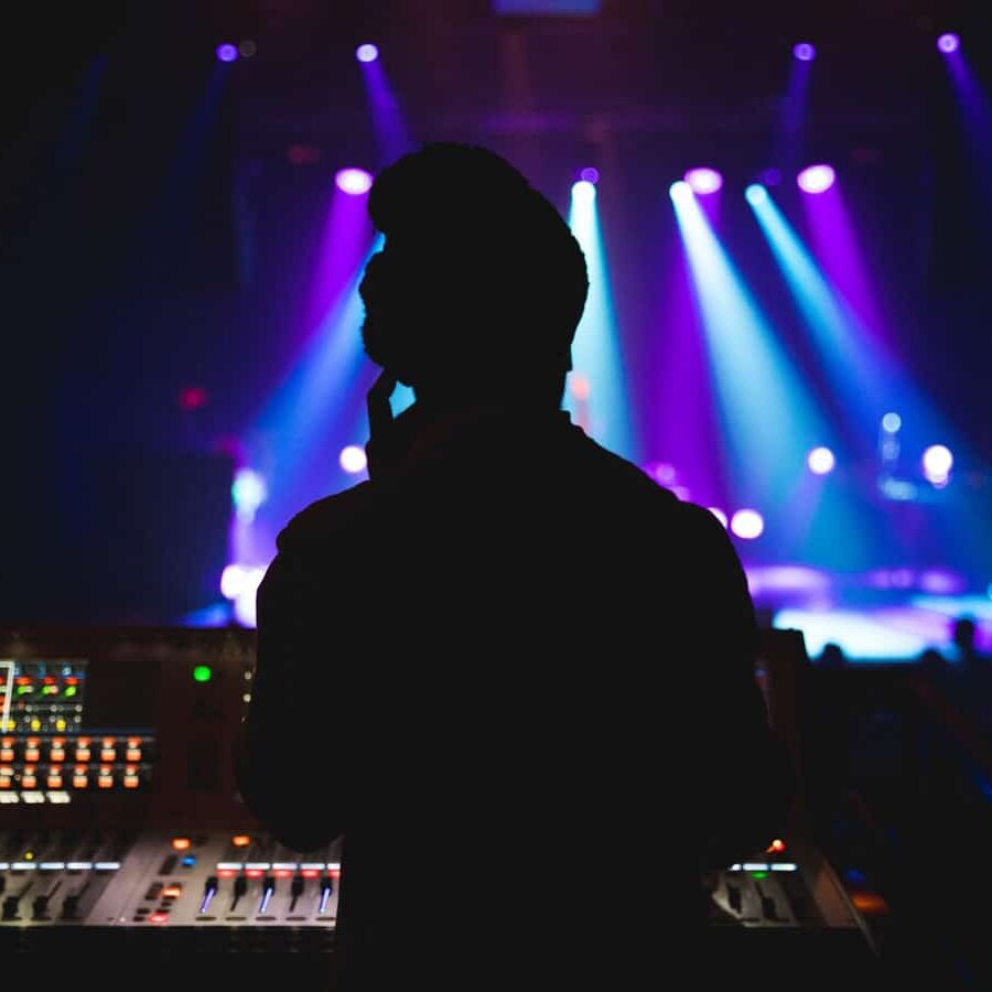 Man standing at soundboard for a concert